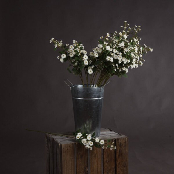 This is the White Wild Meadow Rose. A single spray of small white faux blooms to display within a favourite vase and provide a finishing touch to any interior.