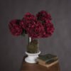 Embrace the opulence of autumn with our Autumn Ruby Hydrangea. This exquisite artificial bloom captures the essence of Hydrangea macrophylla in its most vibrant form. Its deep ruby petals mimick the lush