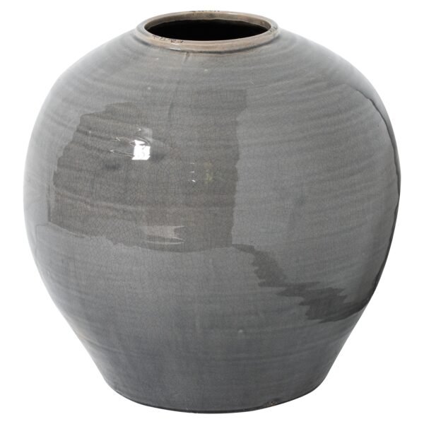 This luxurious ceramic vessel showcases a subtly distressed grey glaze that creates an interplay of light and shadow across its artistically textured surface. The modern silhouette melds seamlessly with diverse interior schemes