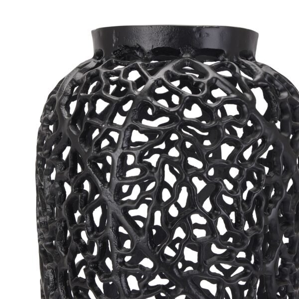 this perforated steel vase commands attention with its distinctive lattice pattern and matte black finish. The intricate geometric cutouts create mesmerizing shadow play while adding visual depth and textural interest to any space. Whether displayed as a standalone sculptural piece or adorned with dramatic twisted hazel branches